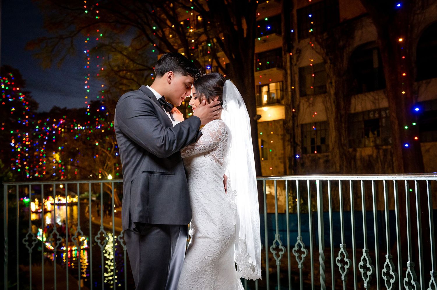 Romantic nighttime wedding portraits with twinkling lights and elegant decor.