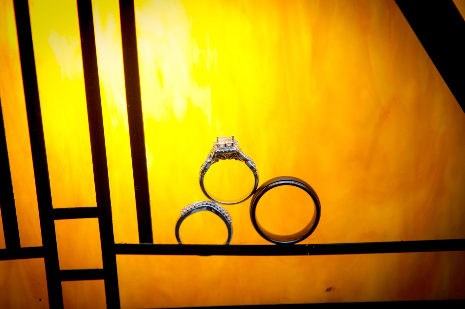 Decorative lanterns silhouetted against a golden yellow background.