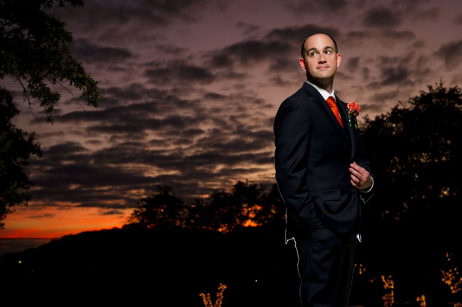 Wedding photography session at twilight with dramatic clouds and sunset colors.