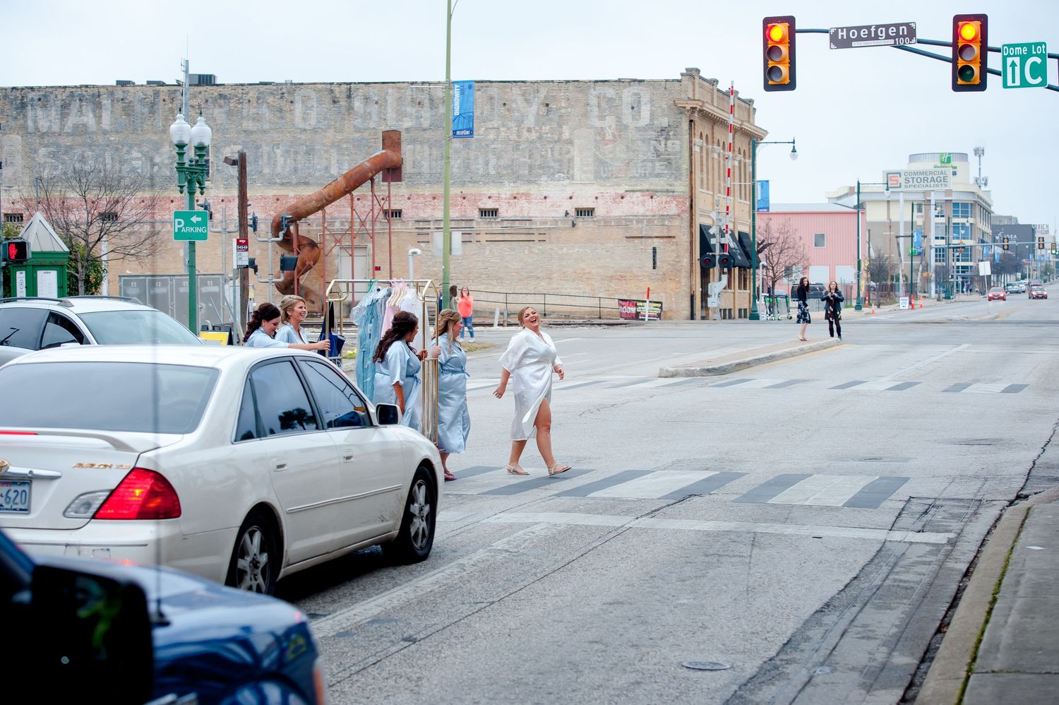 Urban street scene with traffic lights and railroad tracks in downtown area.