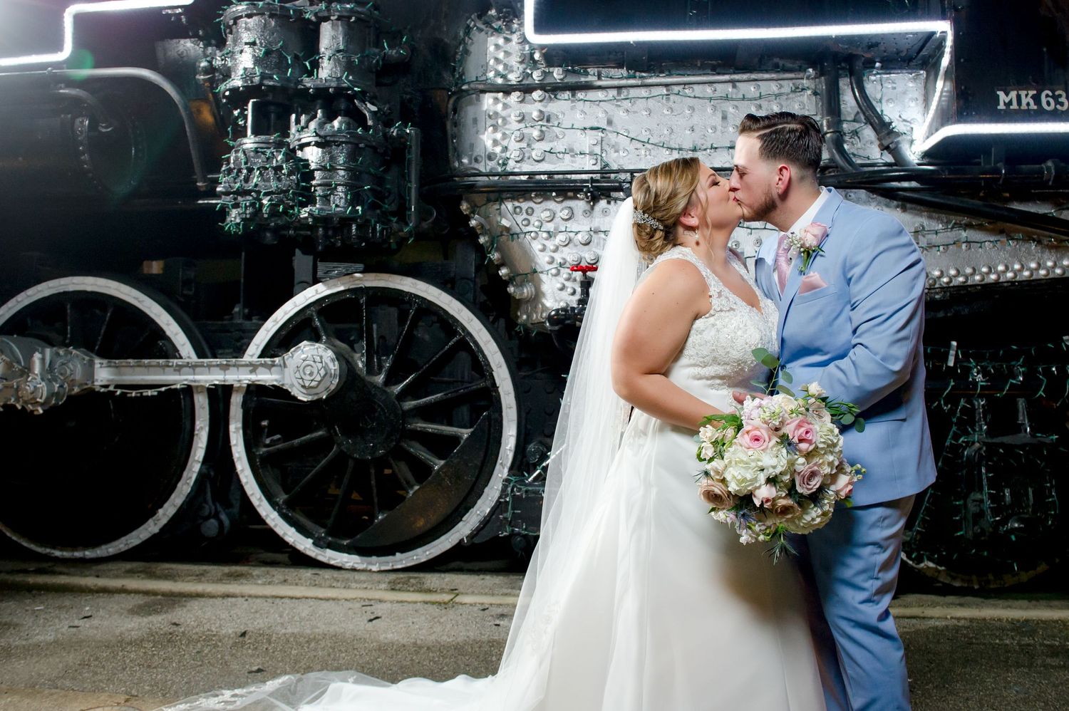 Romantic wedding photo session against an industrial train backdrop.