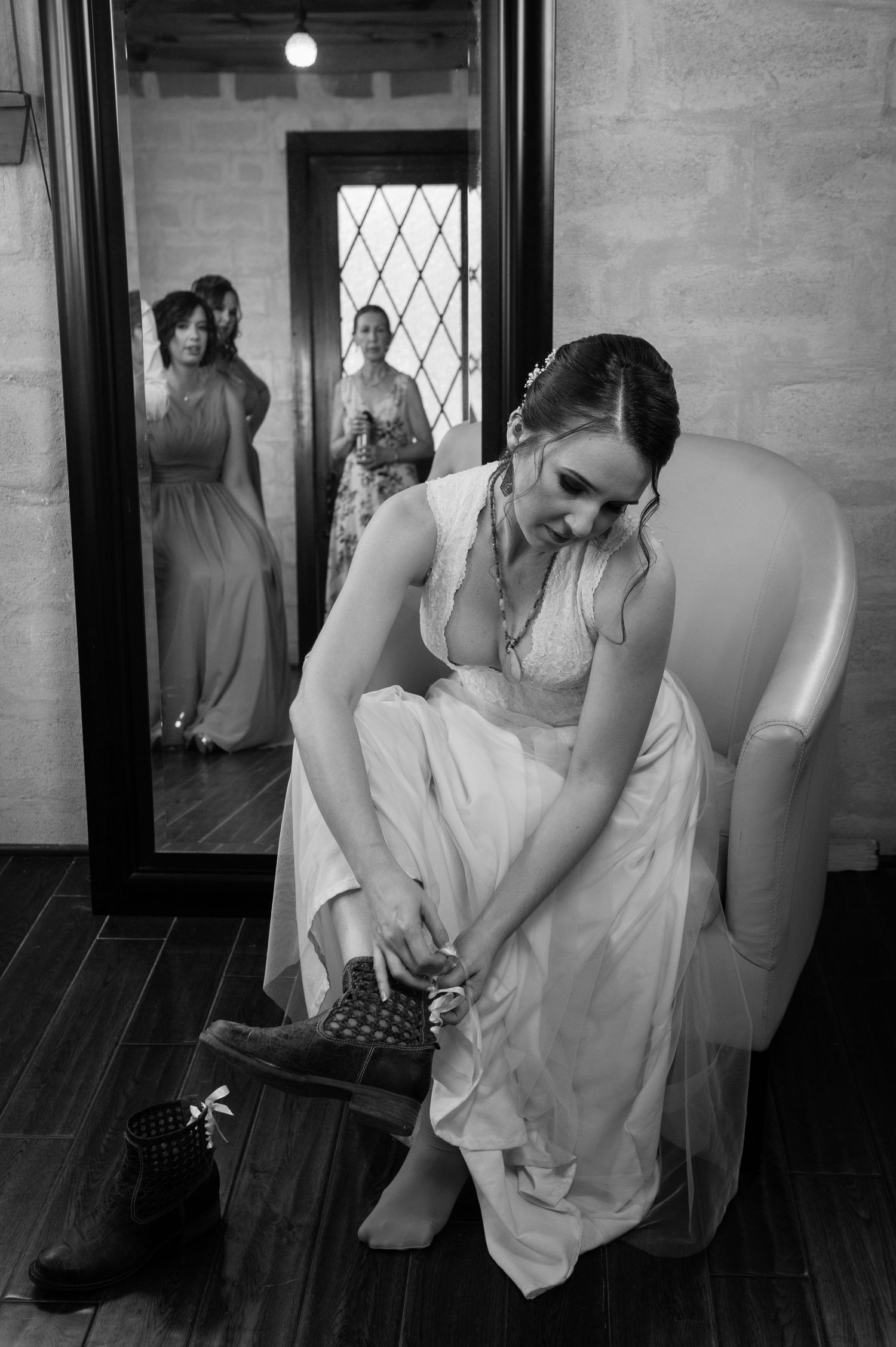 Black and white photo series showing a woman in a white dress being fitted and adjusted on dress forms.