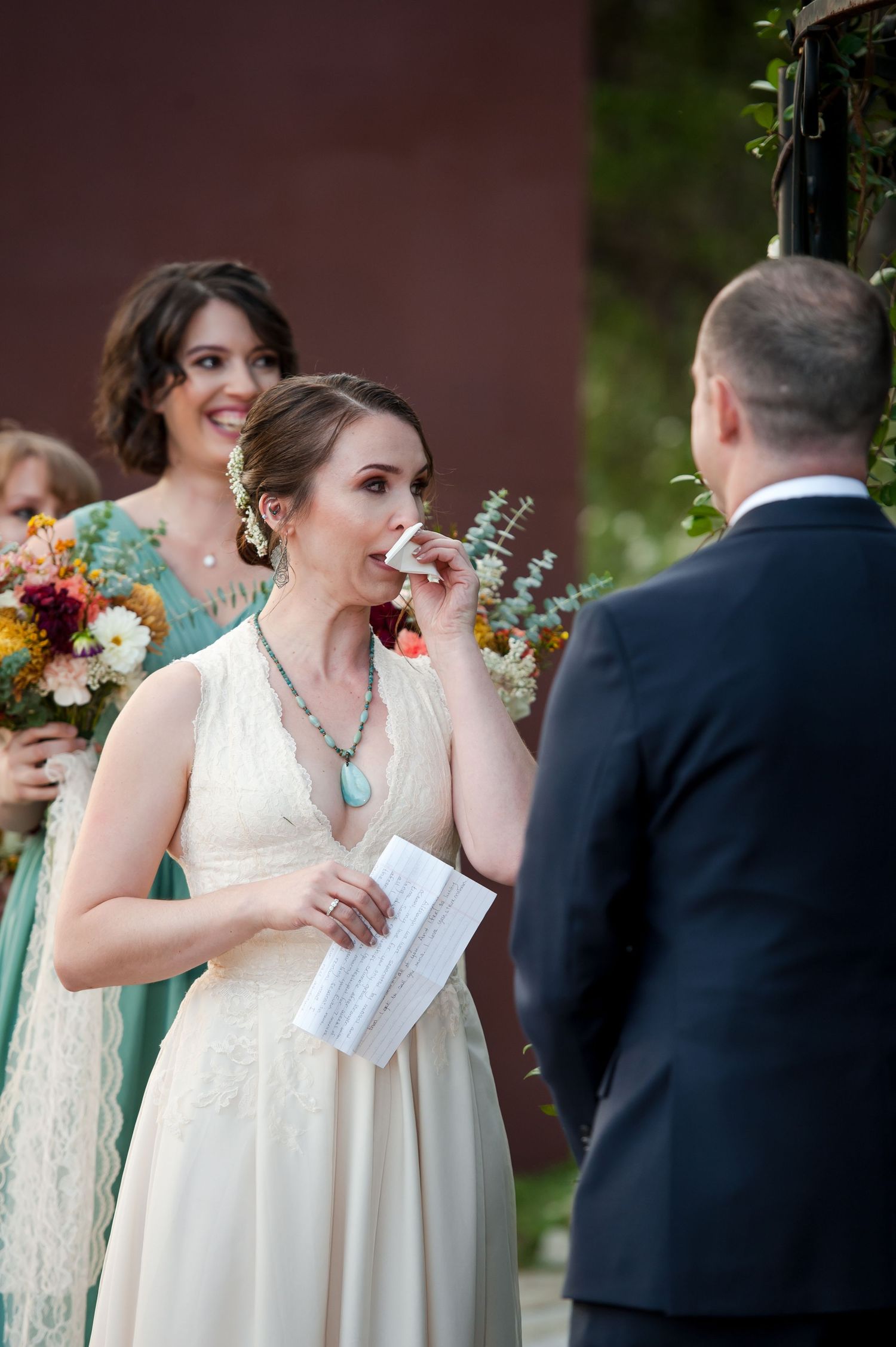 A series of emotional moments during a wedding ceremony showing bridesmaids in white dresses reacting to the vows.
