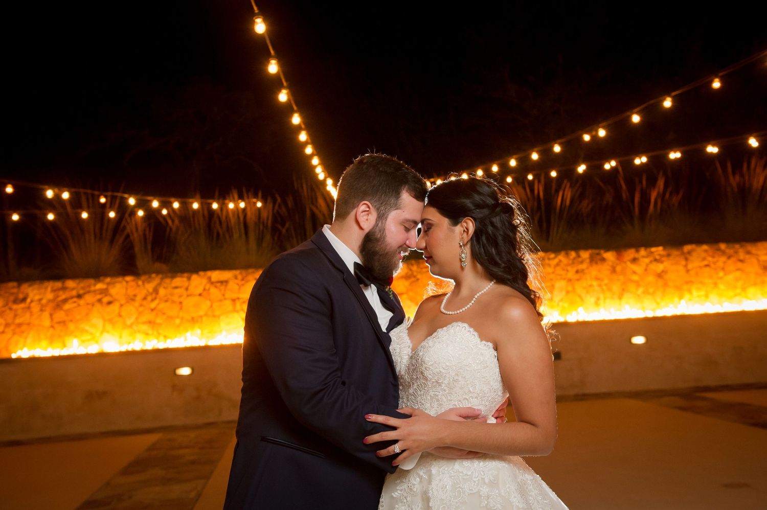 Romantic nighttime portraits with string lights creating magical ambiance.