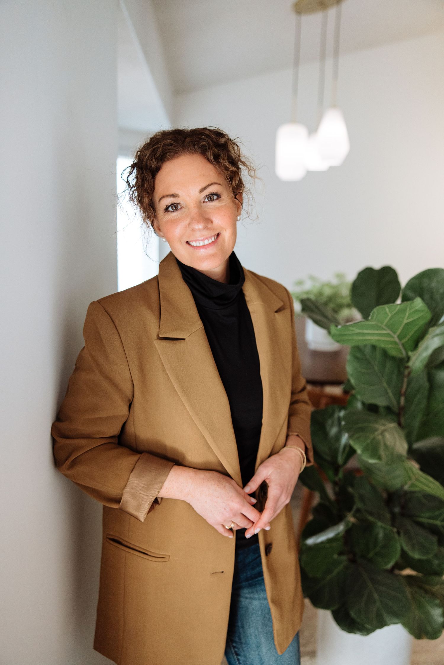 Professional portrait of woman wearing a blazer smiling
