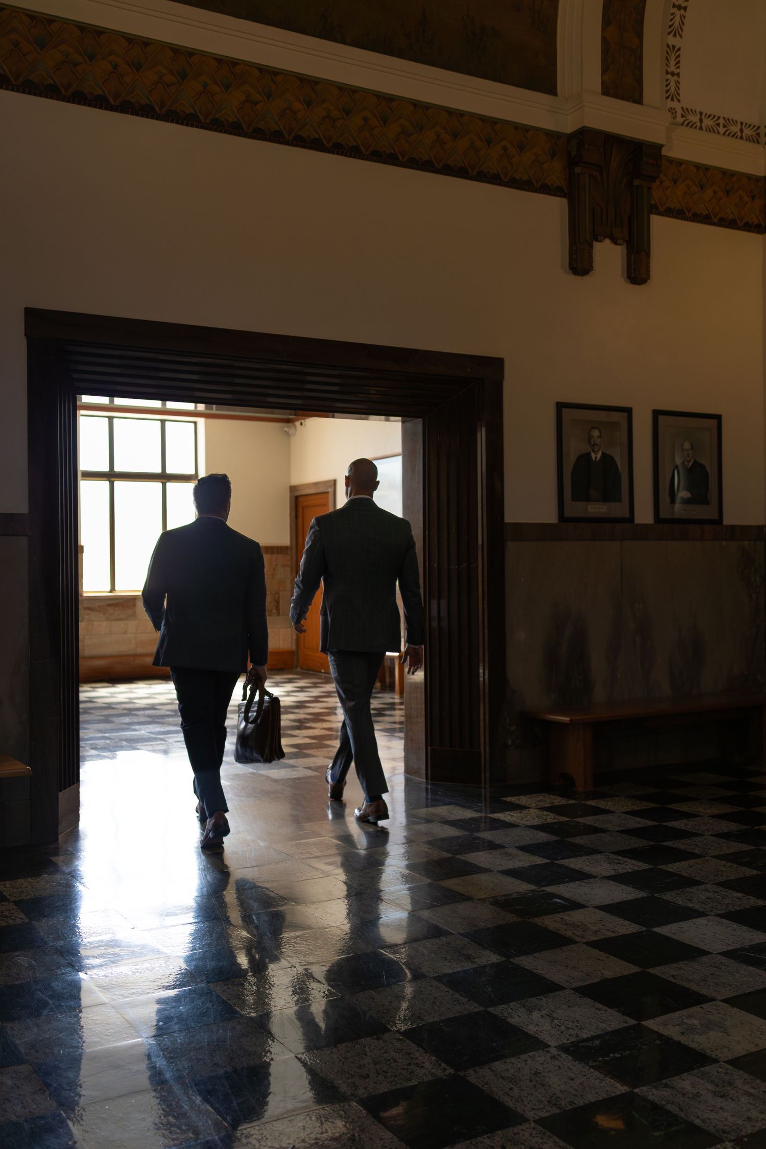 image of attorneys walking out of a courtroom