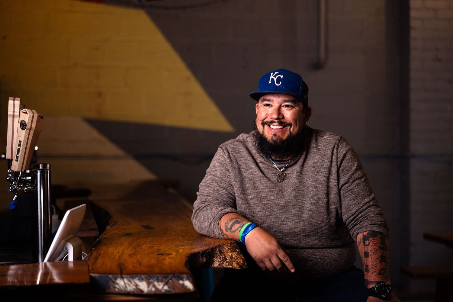 image of man smiling wearing a kansas city royals hat