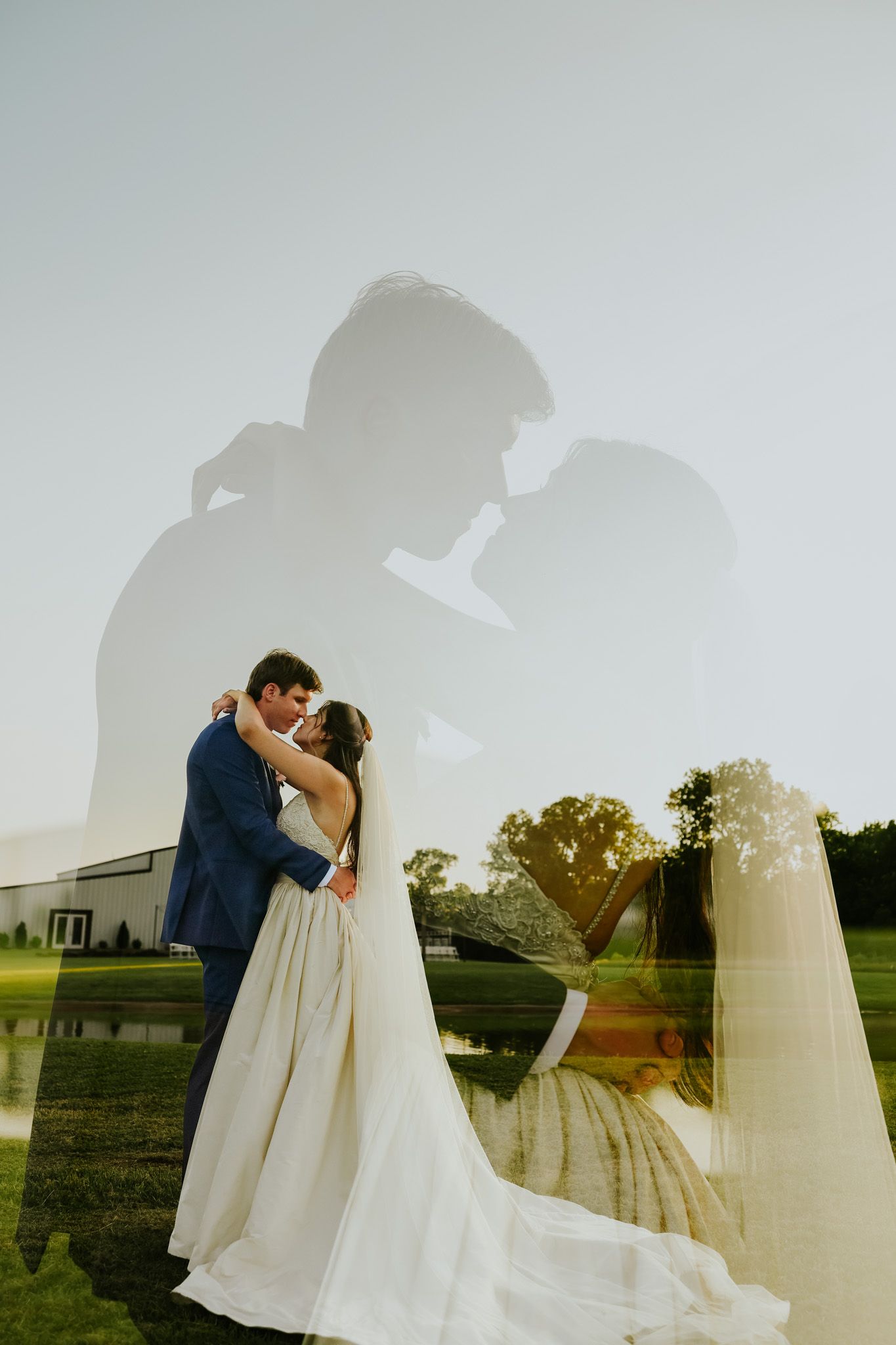Double exposure wedding photo of bride and groom embracing outdoors, with romantic silhouette overlay near a pond.
