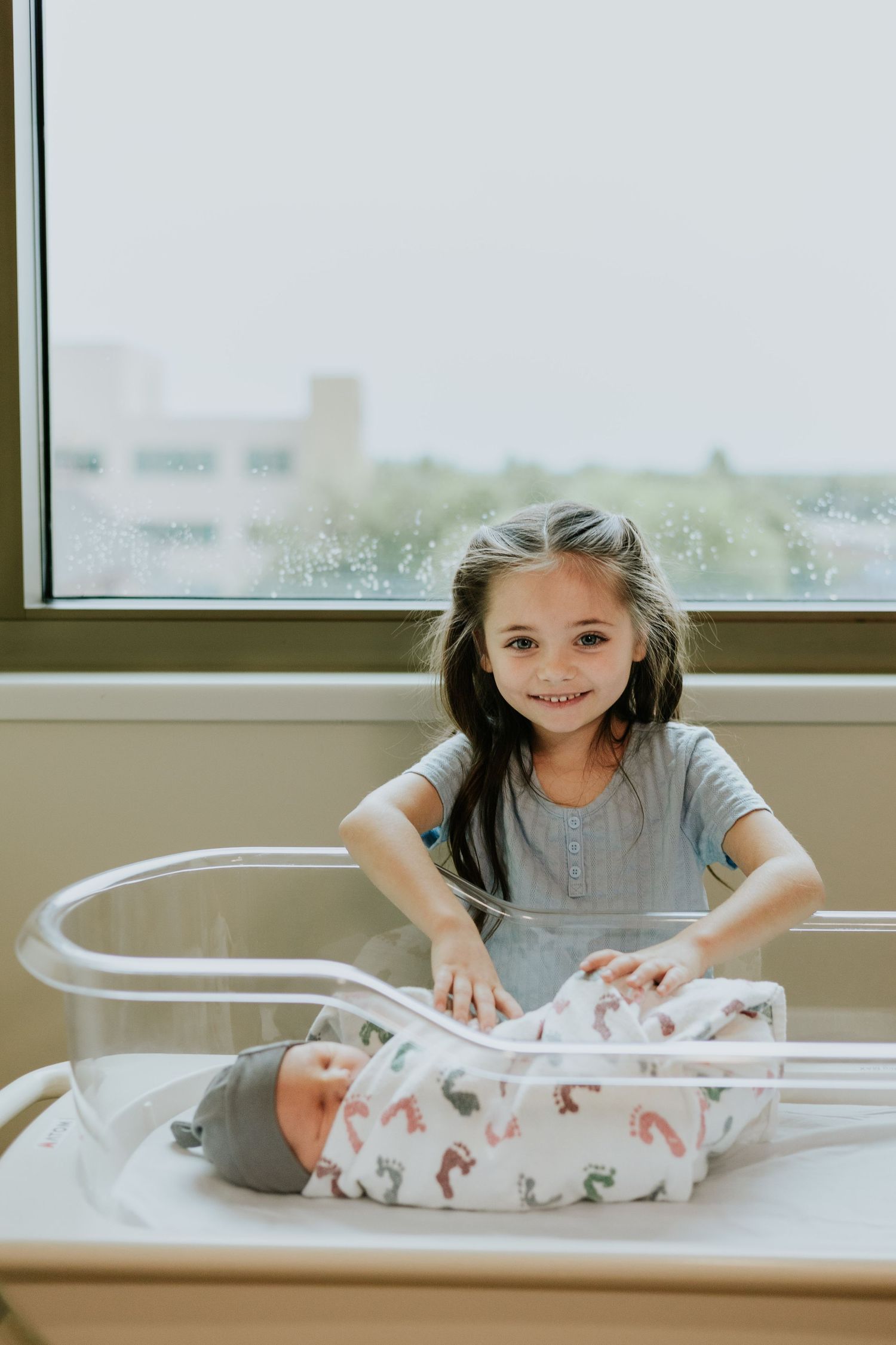 Big sister holding baby brothers hand