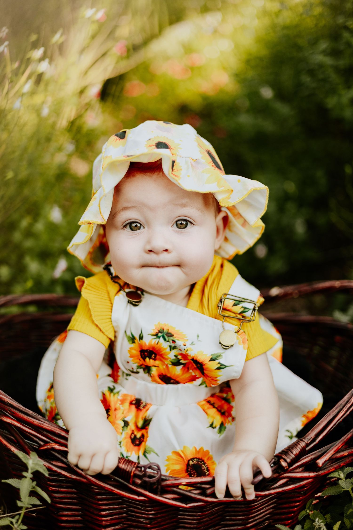 Cute little girl in a flower field with a cute expression