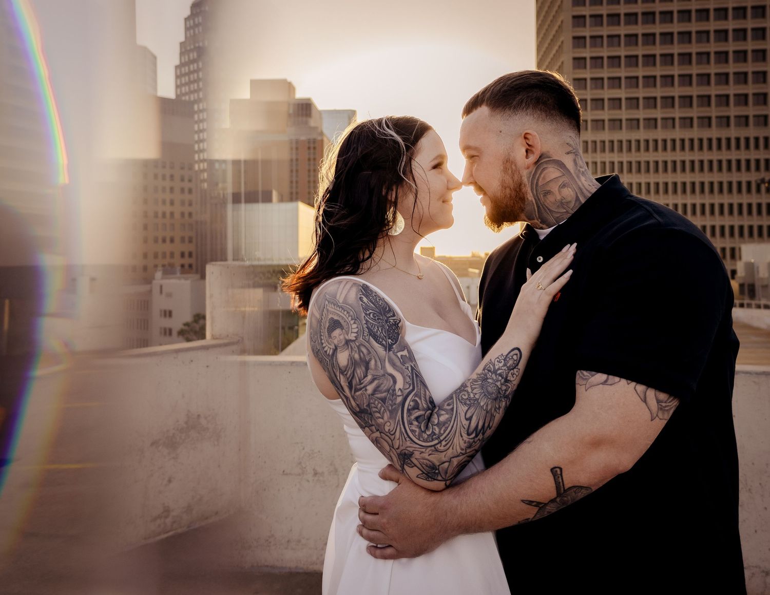 Couple sharing romantic moment on rooftop at golden hour.