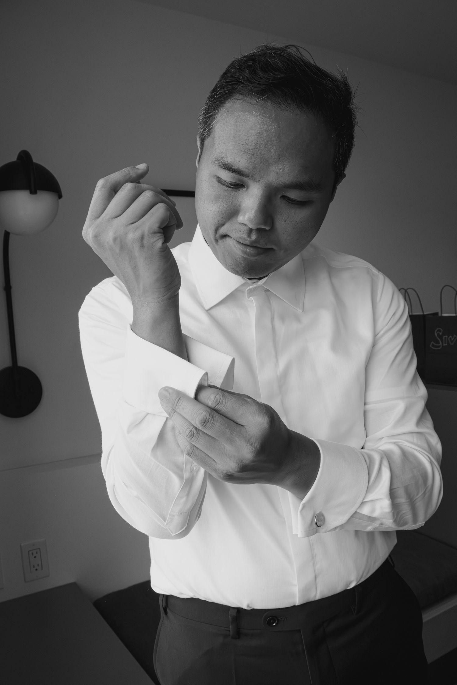 black and white grooms getting ready in hotel room in Ottawa
