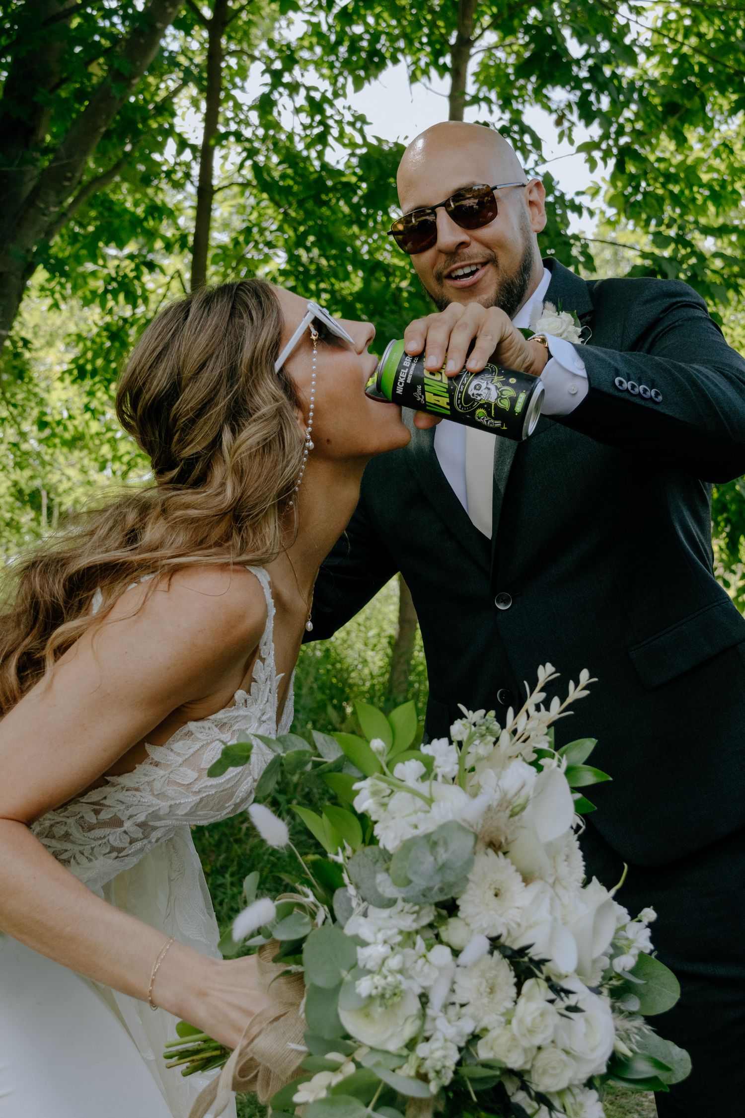 Couple having fun drinking on wedding day