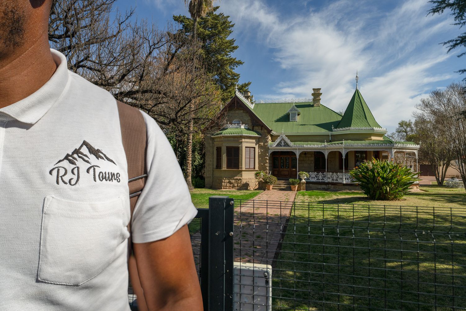 Outdoor shots of people wearing white t-shirts with logo against residential building backgrounds.