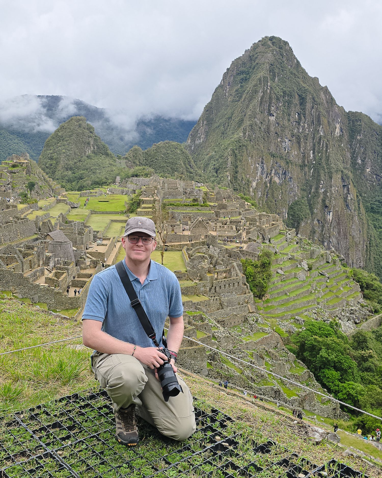 Photographer standing at Machu Picchu overlooking the ancient ruins
