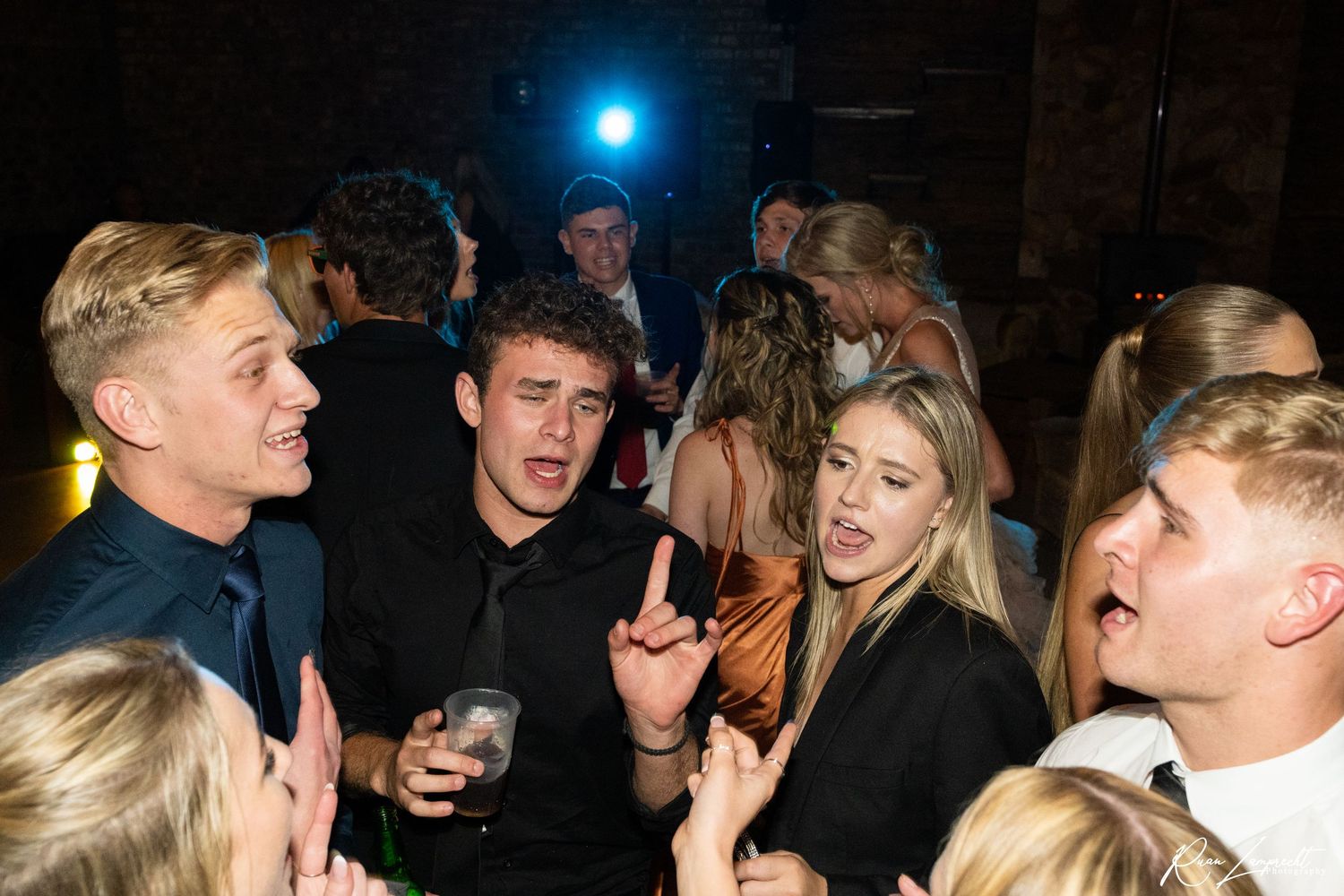 Group of people dancing and enjoying a social event at night