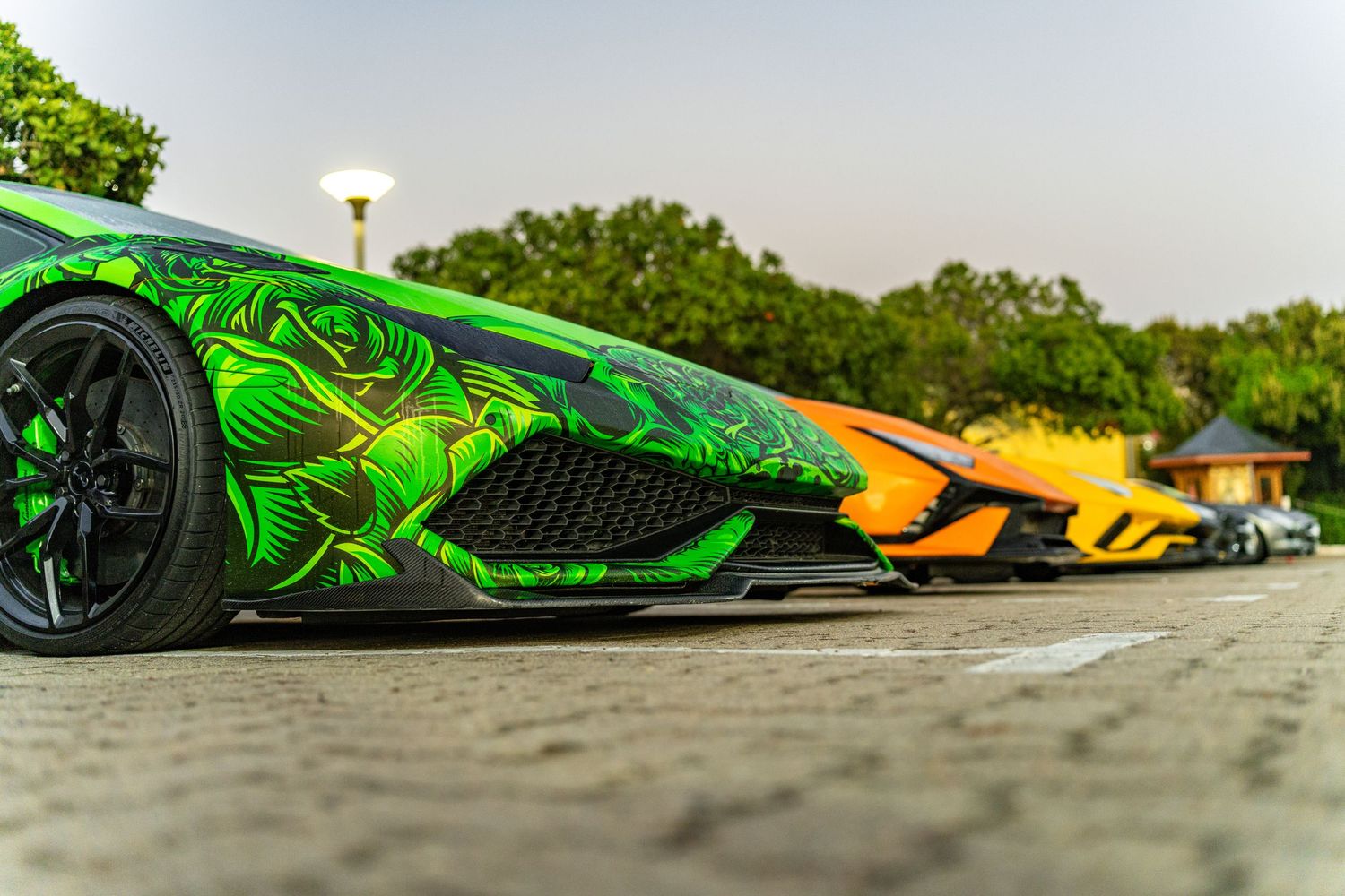 Line of Lamborghini supercars parked at a car show in Mossel Bay