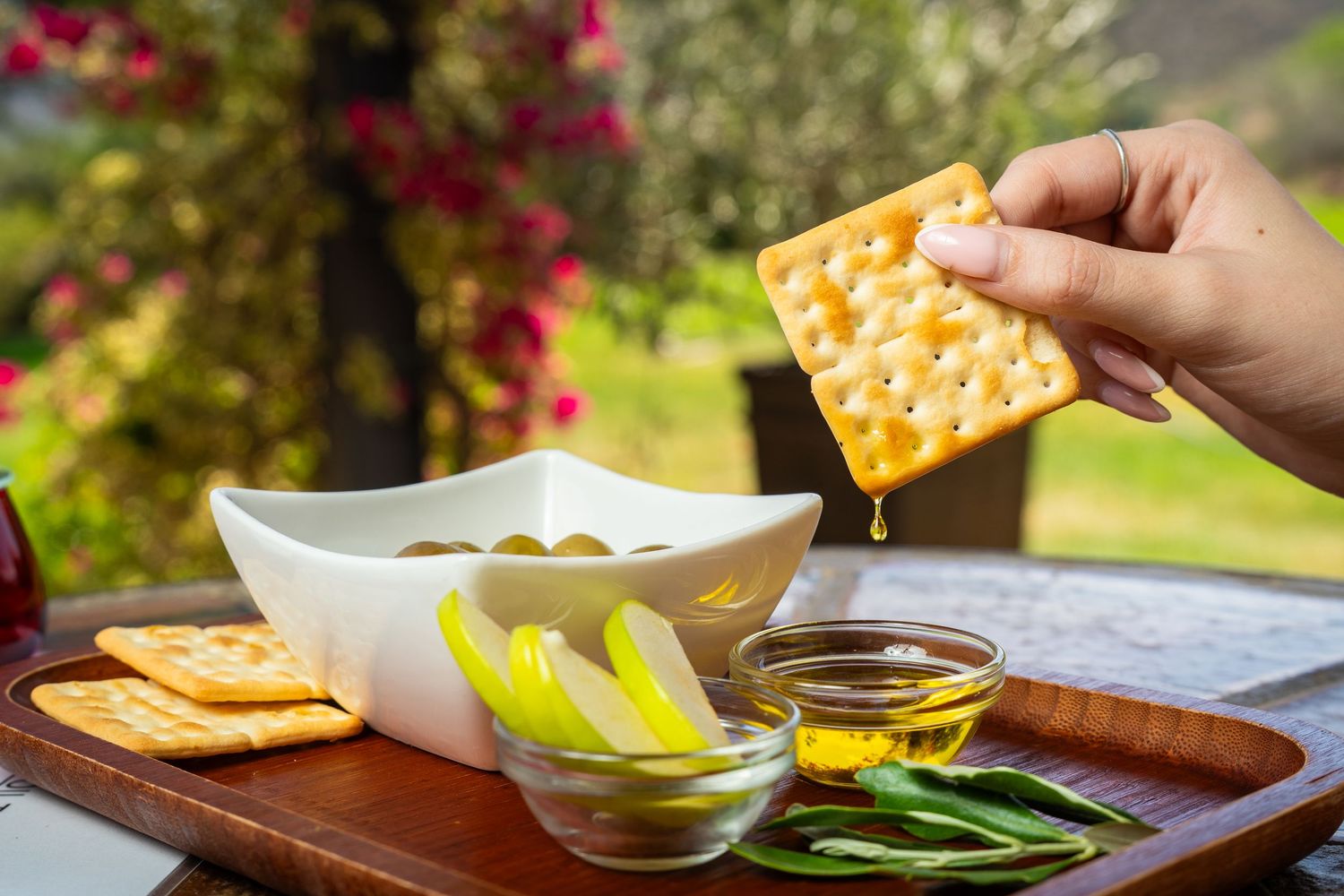 Olive oil dripping from a cracker