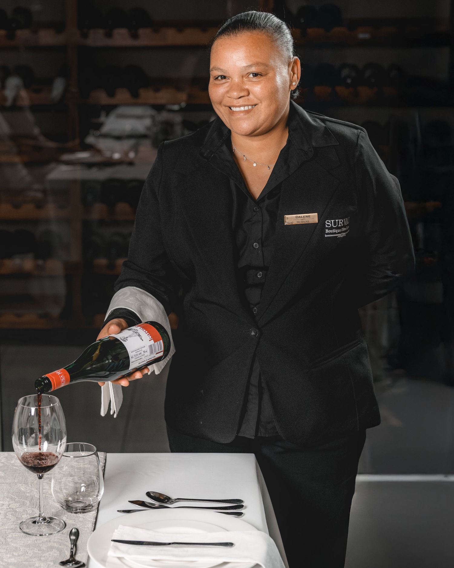 Photo of a waiter pouring wine into a glass at Surval, Oudtshoorn
