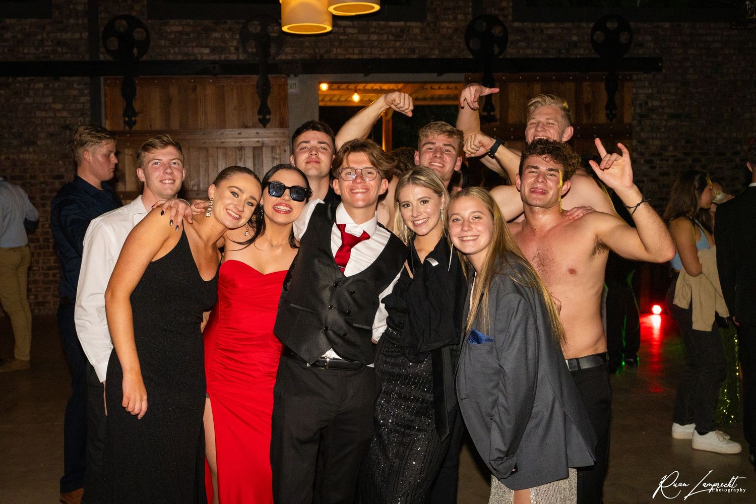 Group of young adults posing for a photo at a social event night