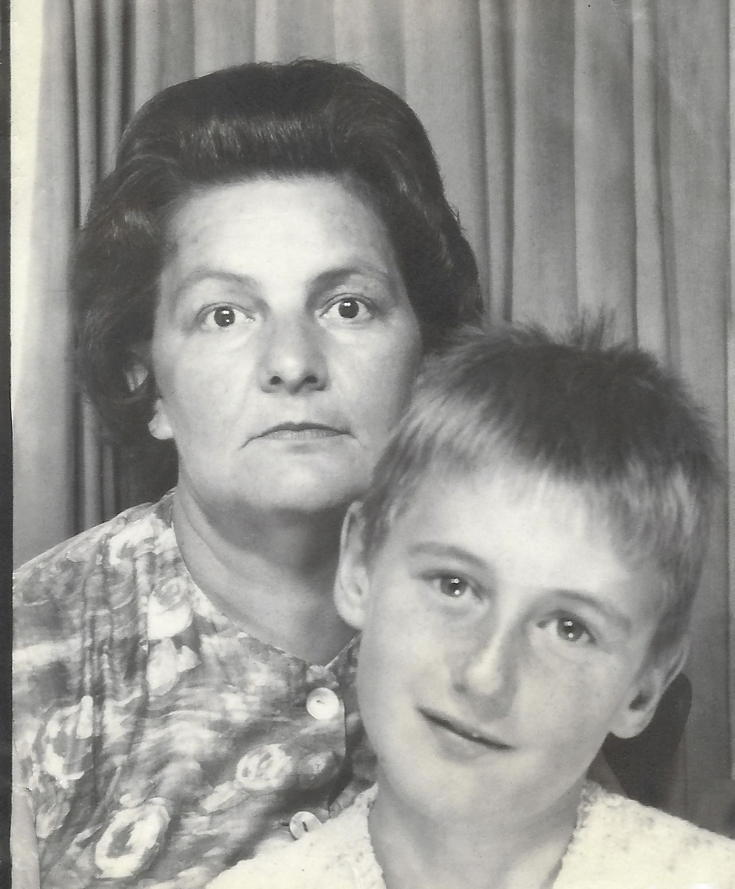 Vintage black and white portrait of a woman and young boy in a studio setting.