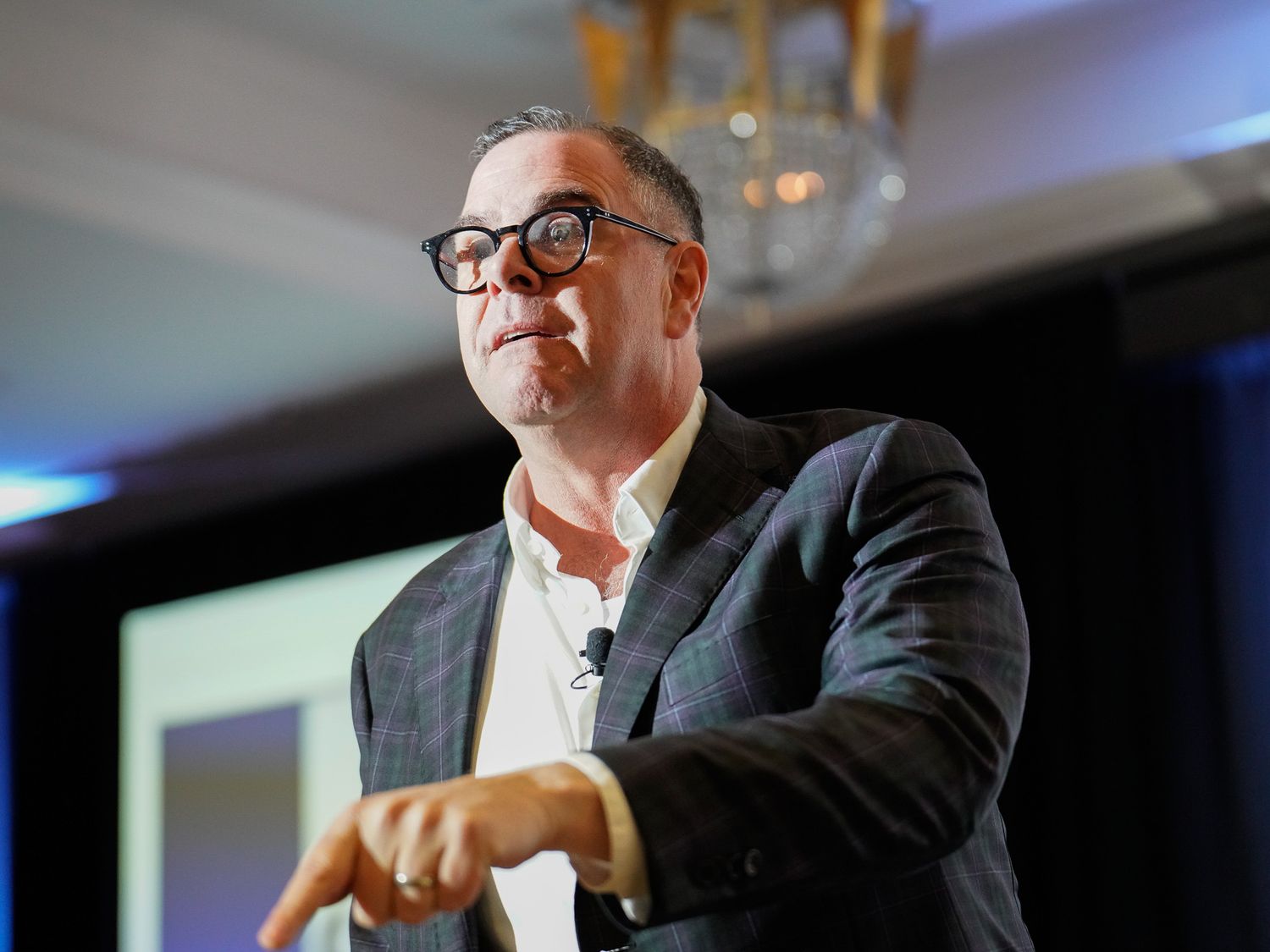 Business executive speaking at podium during professional conference.