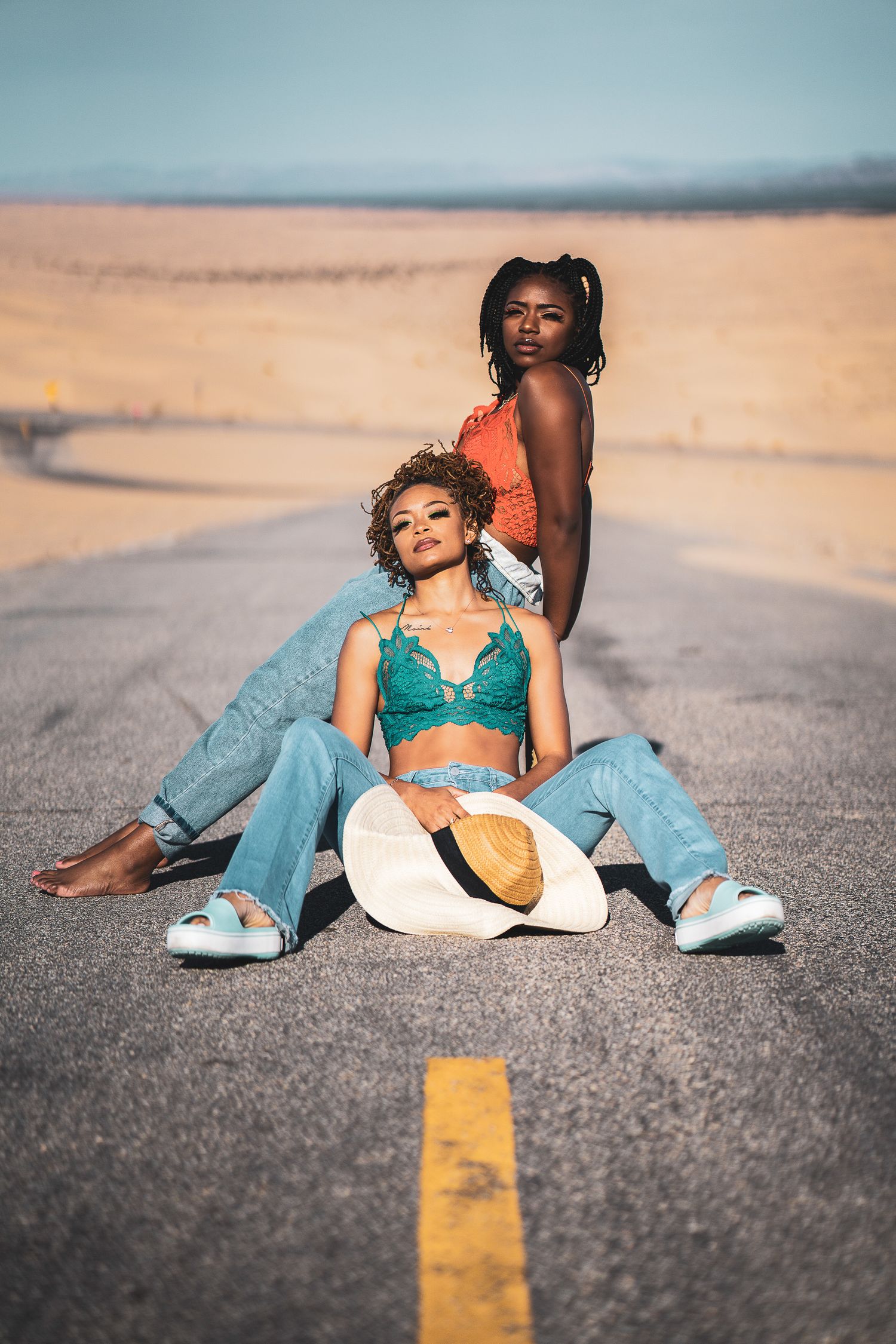 Creative street photoshoot with turquoise outfit and yellow road markings.