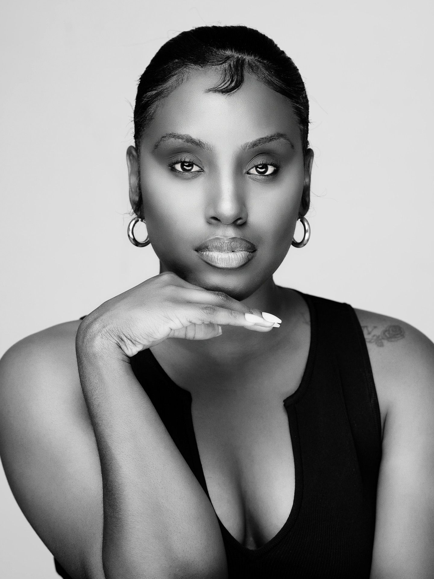 Black and white portrait series showing elegant poses and expressions in sleeveless attire.