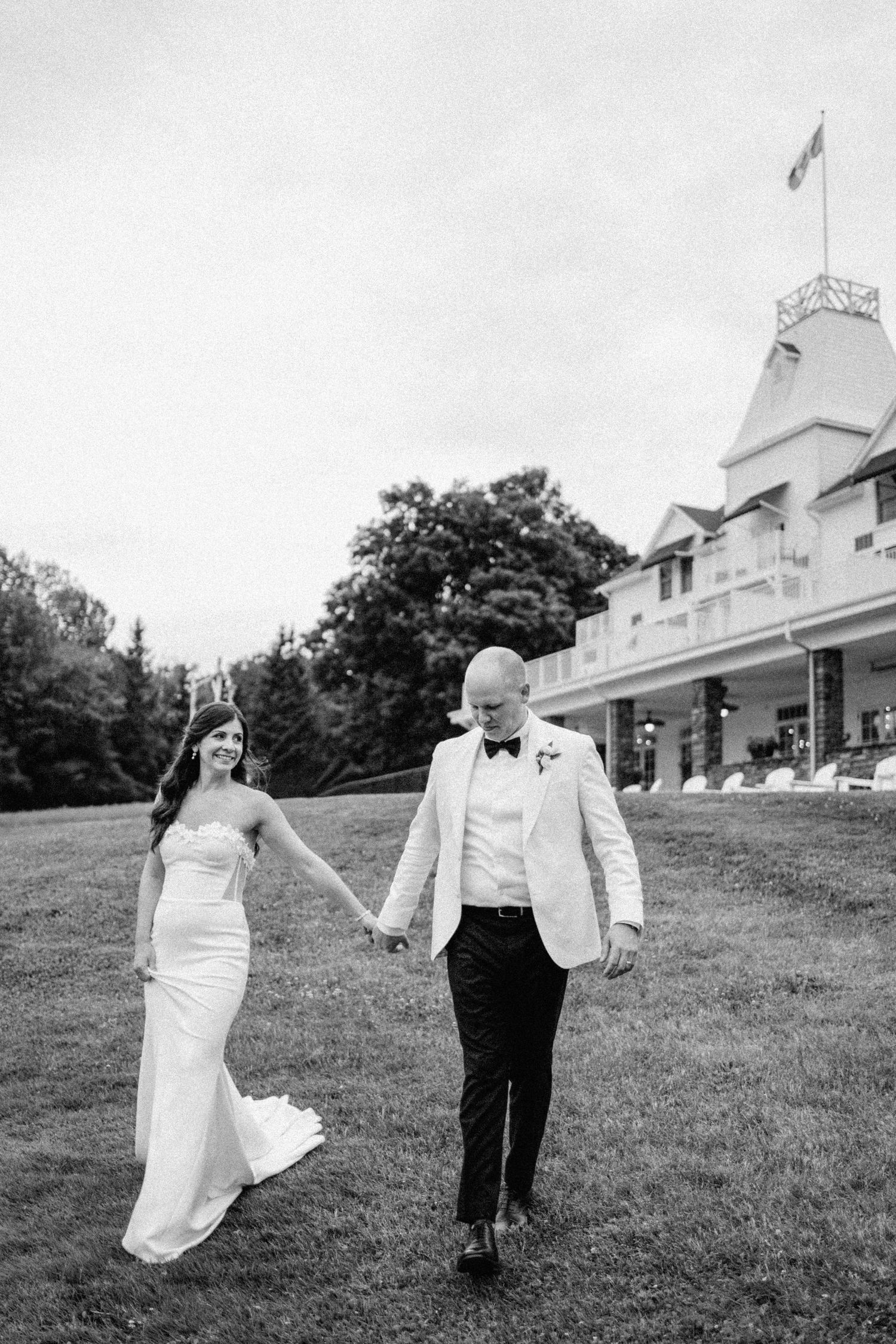 Bride and groom sharing an emotional moment on the grass at Windermere house, Muskoka- Huntsville wedding photography