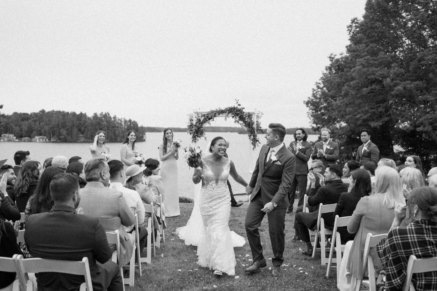 Black and white photo showing wedding ceremony on the front lawn of Windermere house-Alexi Anne Photography-Muskoka wedding photographer