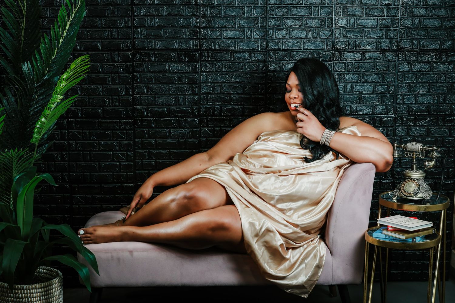 Elegant boudoir portrait on chaise lounge with silk wrap.