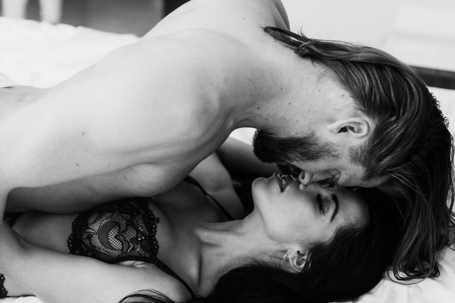 Black and white intimate portrait with dramatic lighting.