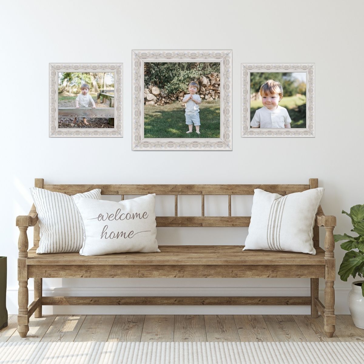 Three professional portraits of a young boy hang in ornate white frames above a rustic wooden bench.