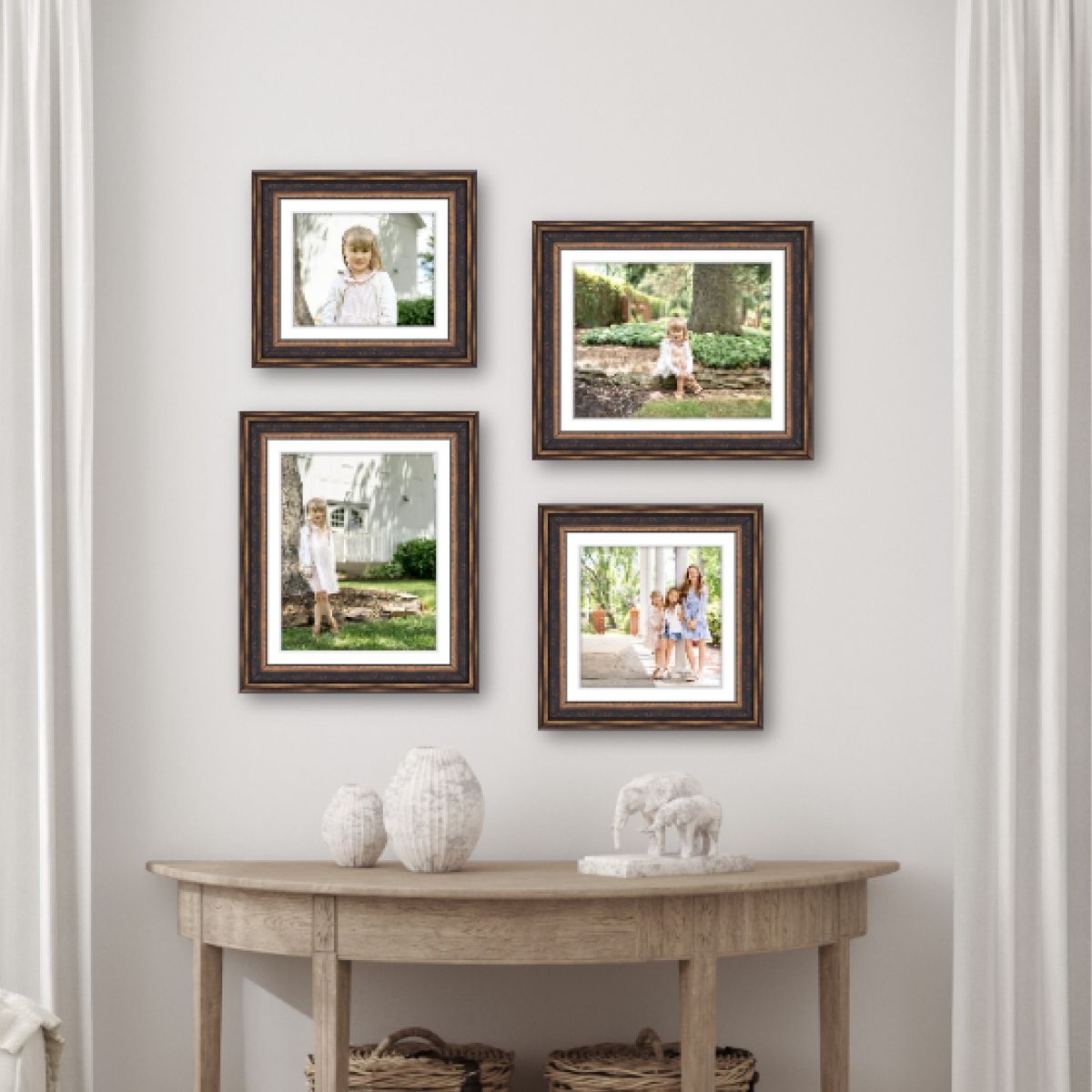 Four wooden professionally framed photos by a Lancaster, PA photographer hang on a light gray wall above a console table with white decor.