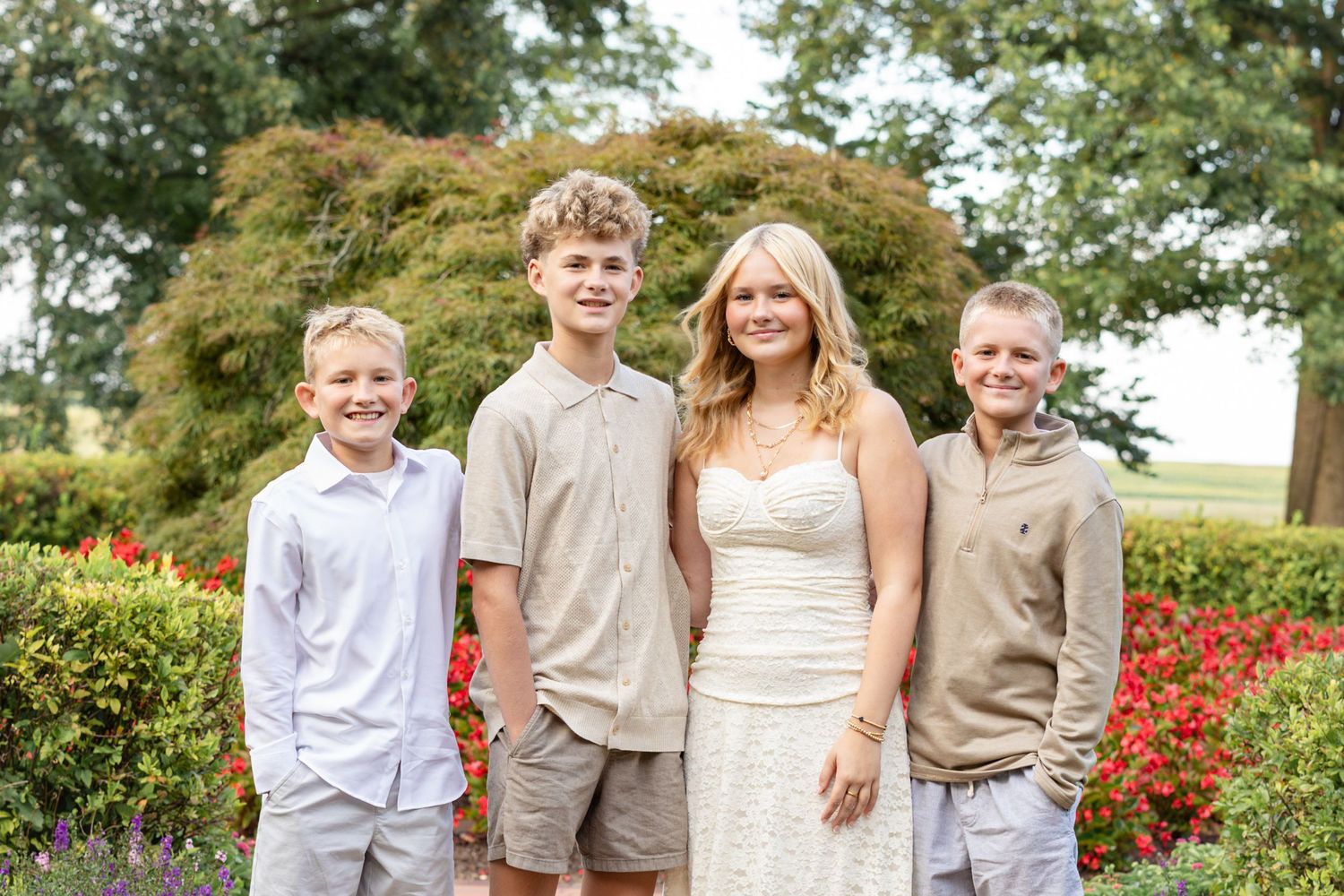 Senior portrait of high school girl with her siblings posed at Founders Hall in Hershey, PA
