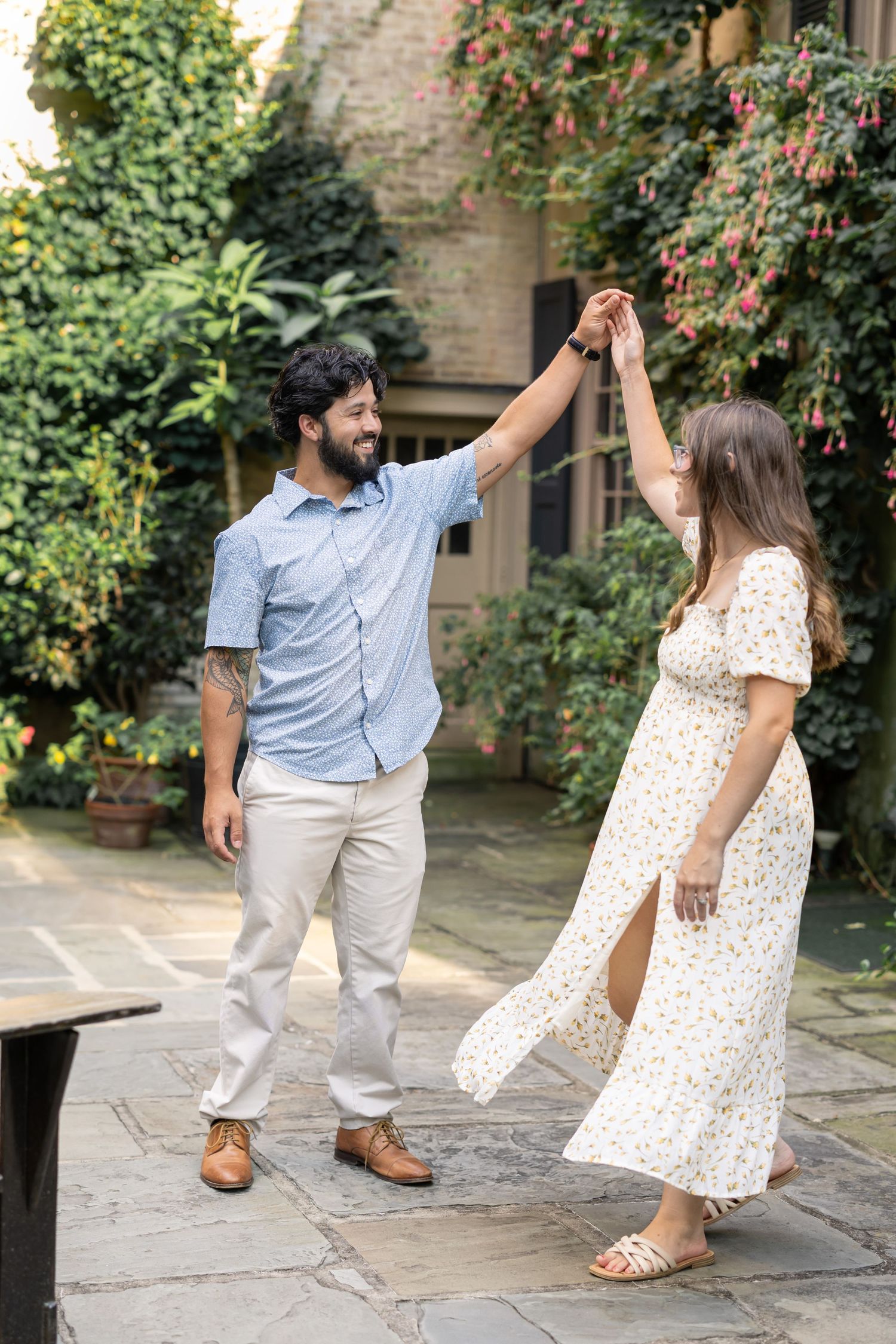 A luxury couples session shows a young couple dancing in the garden during candid family photos in Lancaster, PA.