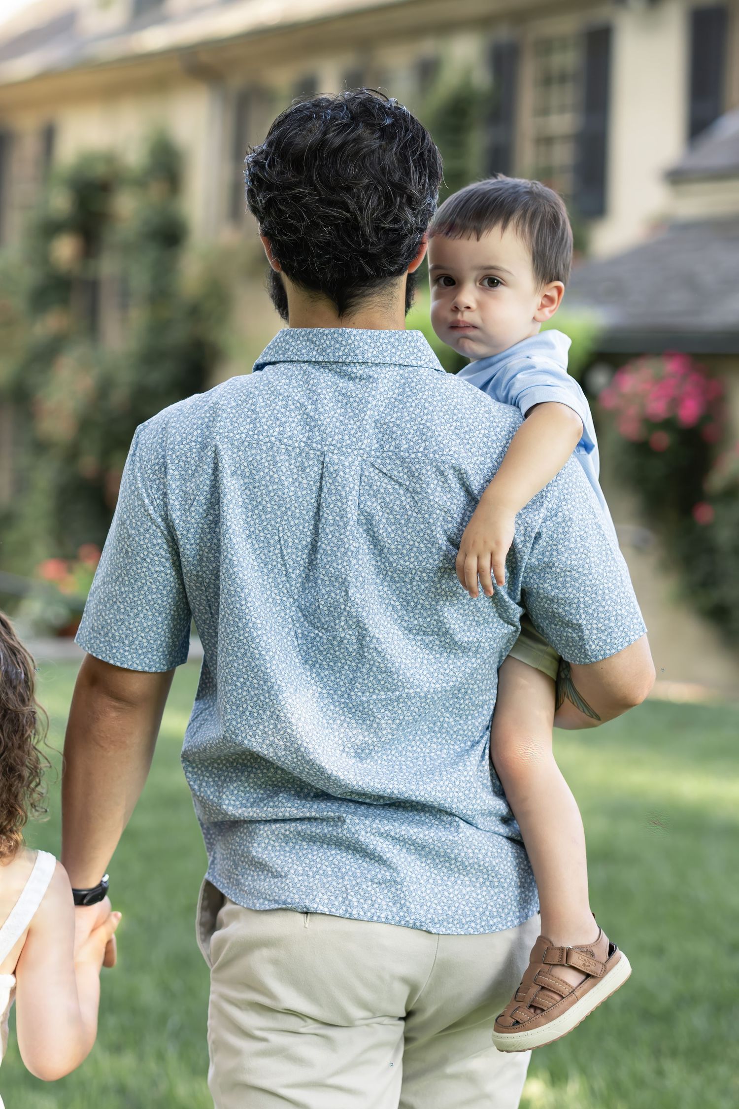 A candid moment as a boy looks over his father's shoulder at the prestigious Conestoga House and Gardens in Lancaster, PA.