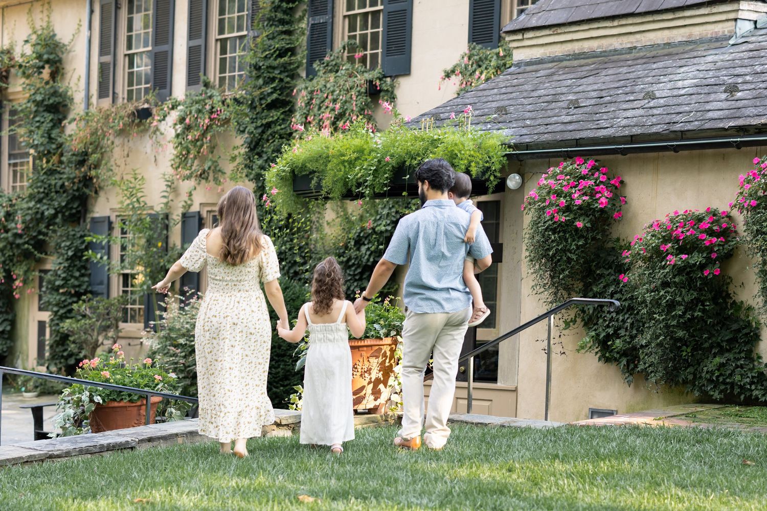 A series of four connected photos showing people walking and sitting in a lush garden setting with stone buildings.