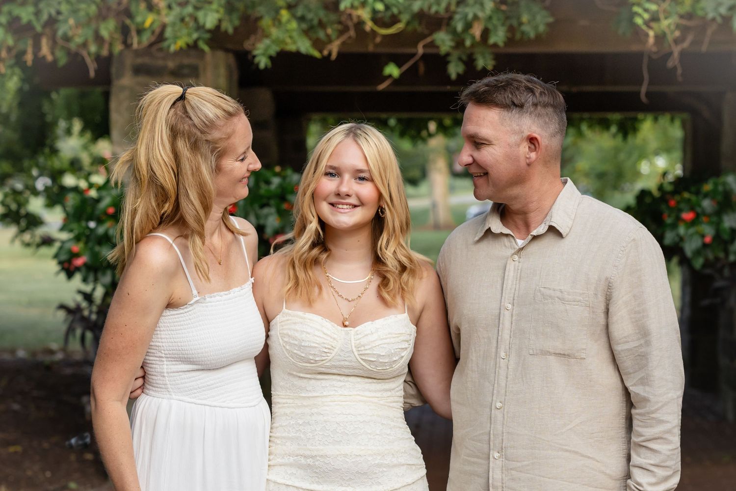 senior girl enjoying time with parents before high school graduation