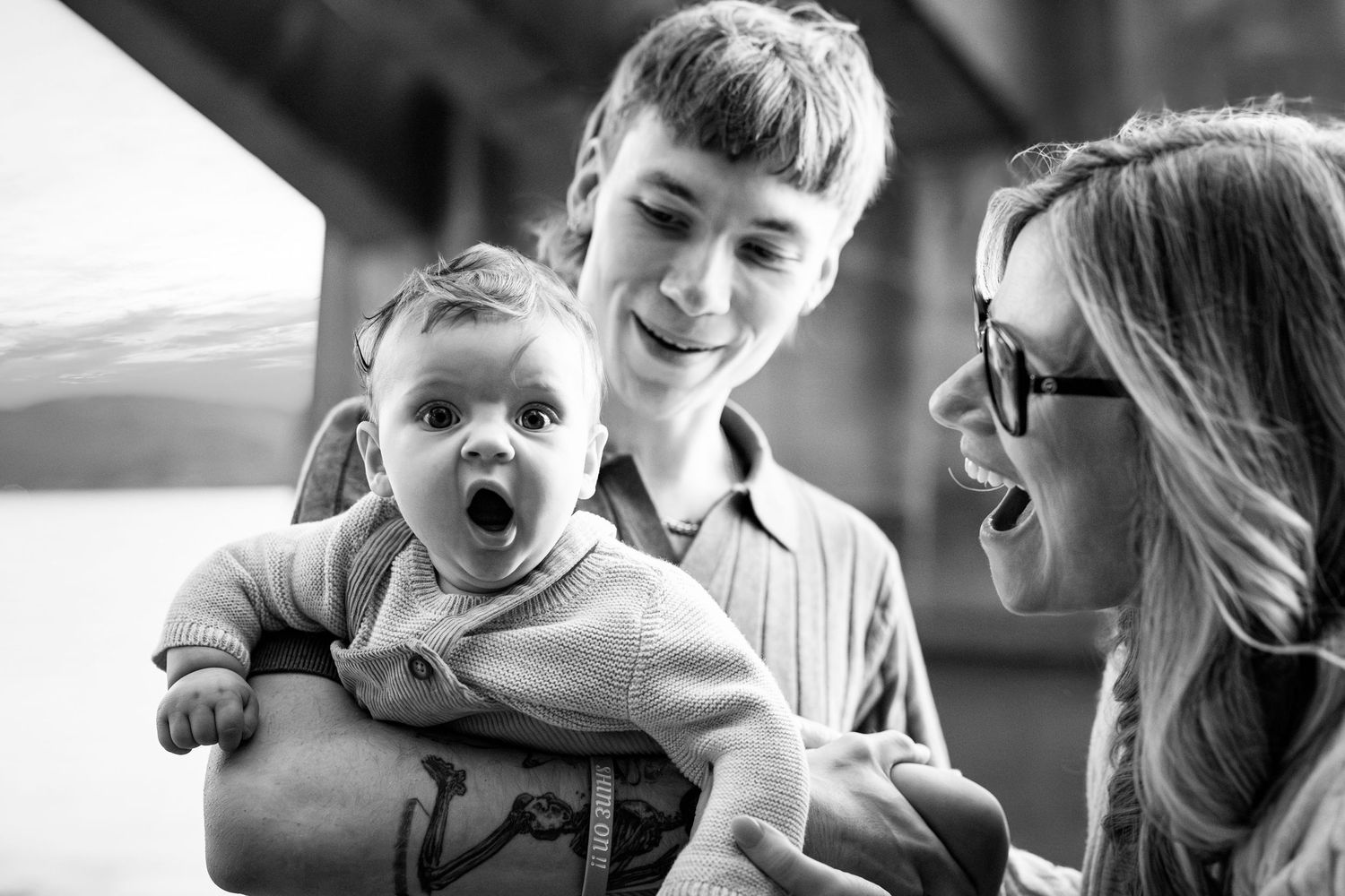 Series of candid black and white family moments captured in natural light.