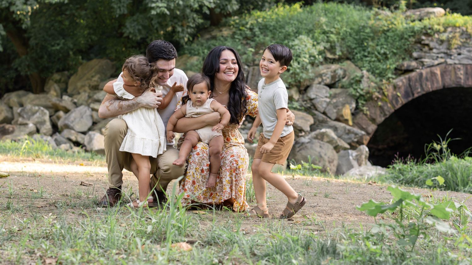 Candid moment as family of 5 embraces at the mill at manor falls in Lancaster, PA.