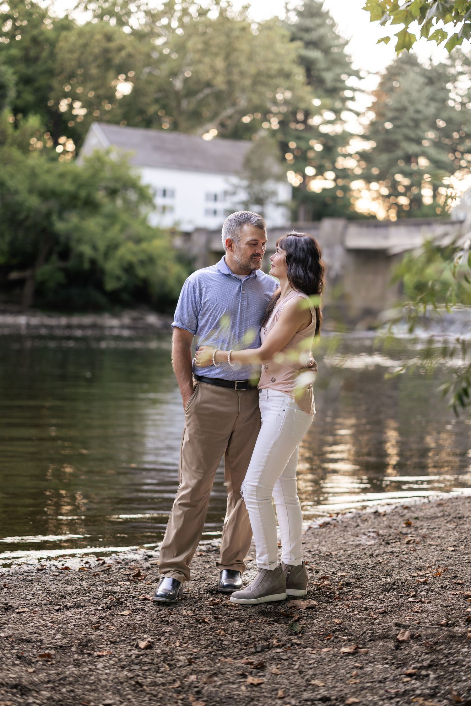 Series of romantic portraits taken by a lake at sunset with natural lighting.