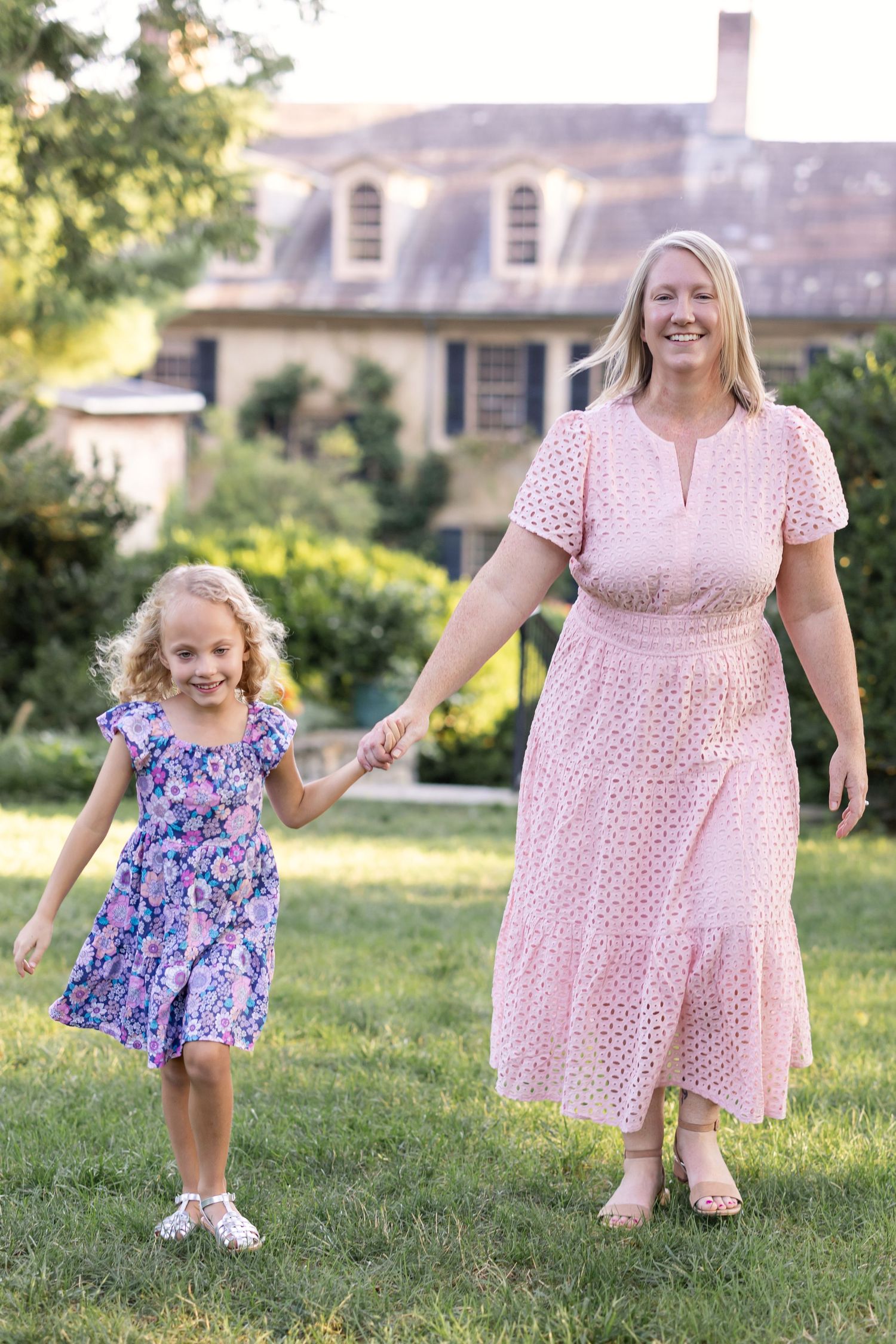 A Lancaster, PA photographer captures a mother and daughter strolling hand in hand at Conestoga House and Gardens.