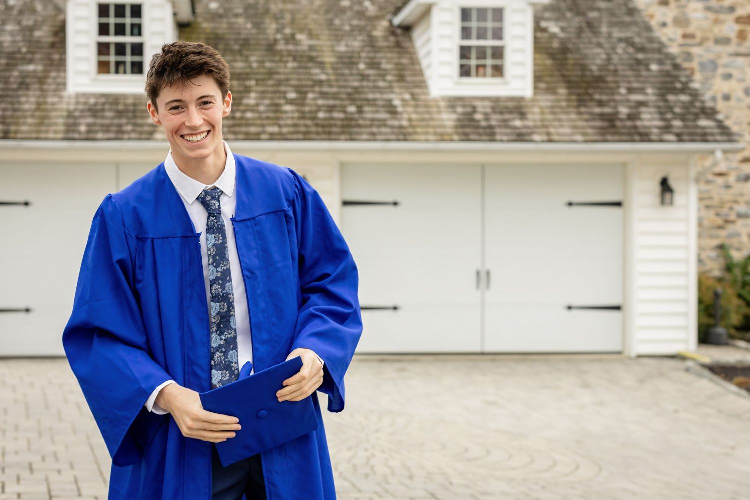 candid cap and gown photo of high school senior boy in Lancaster, PA