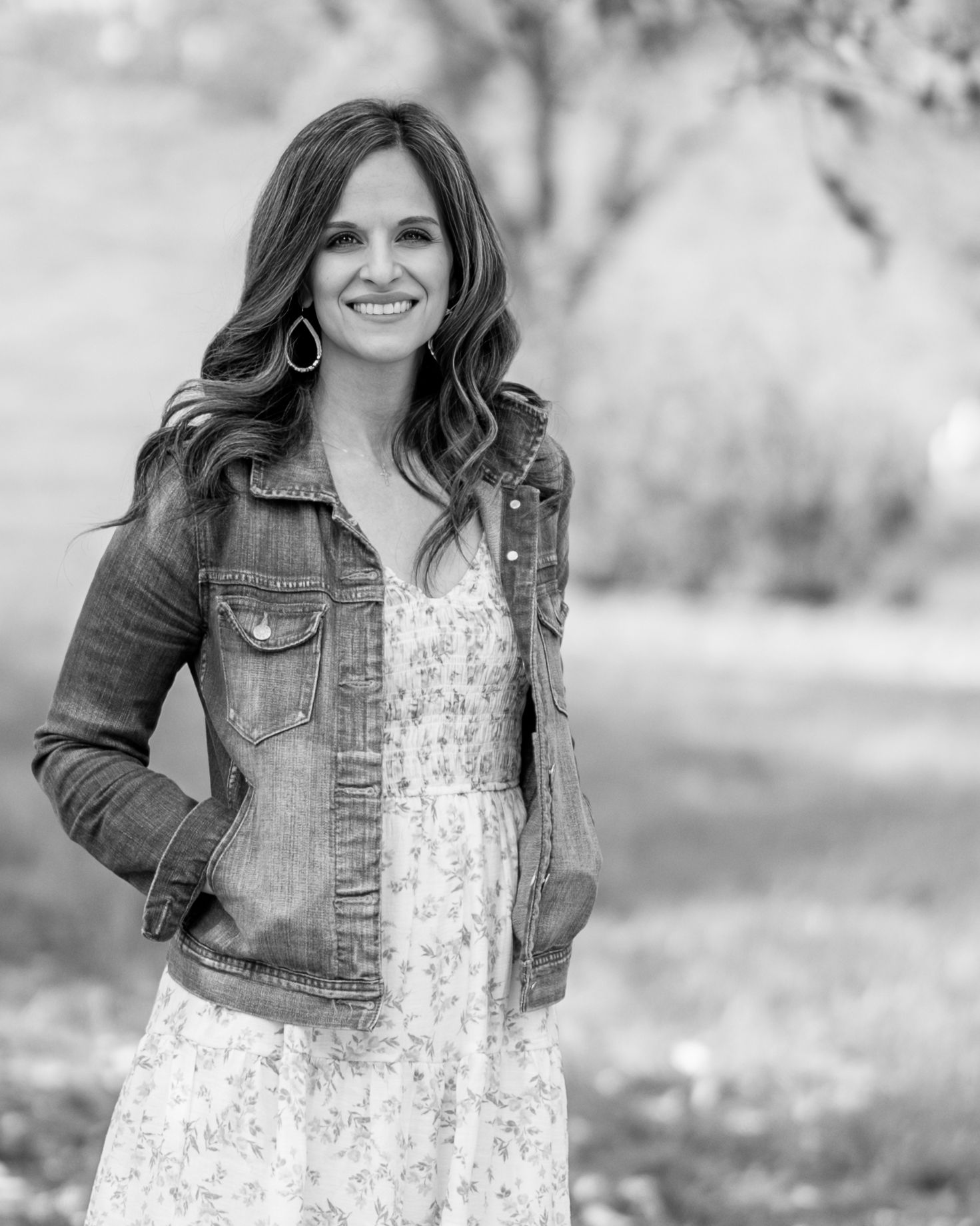 Megan Mariah, a professional senior and family portrait photographer based in Lancaster, PA smiles for a natural light outdoor headshot.