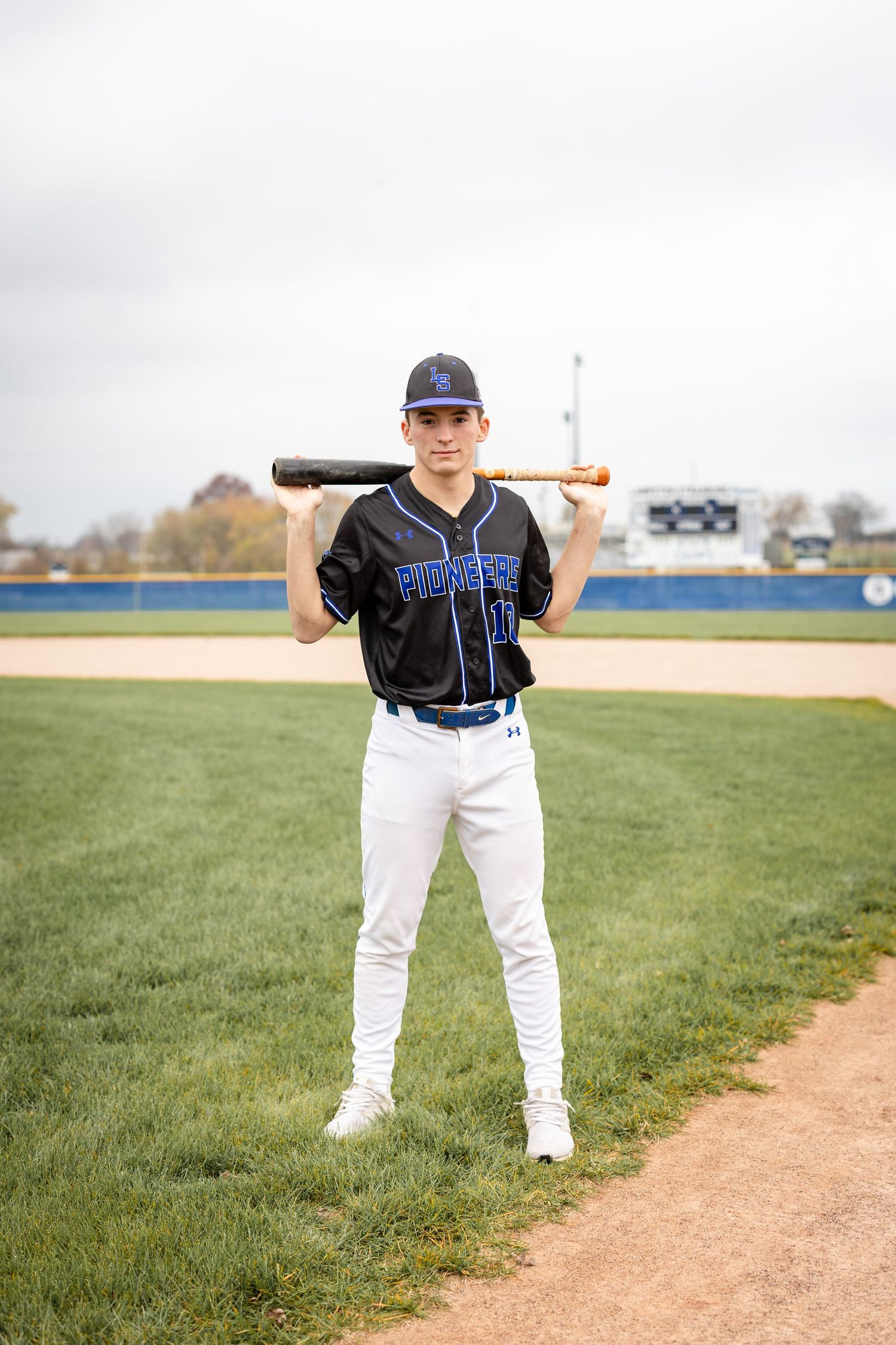 High school senior baseball player photographed on the field in uniform