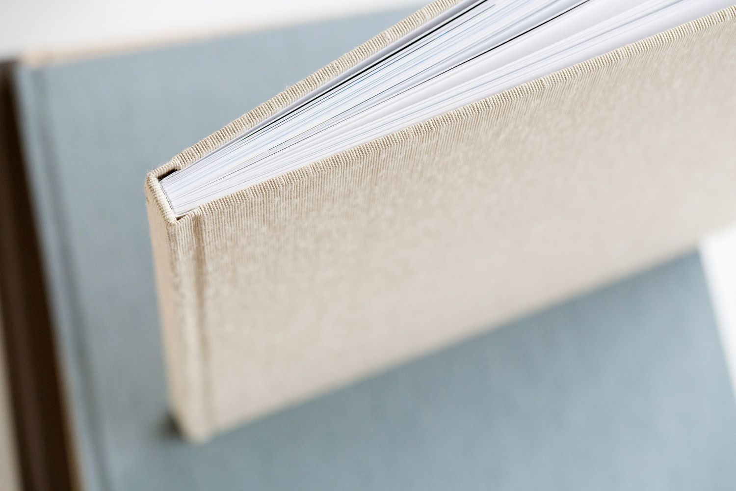Close-up view of a beige linen heirloom photography album