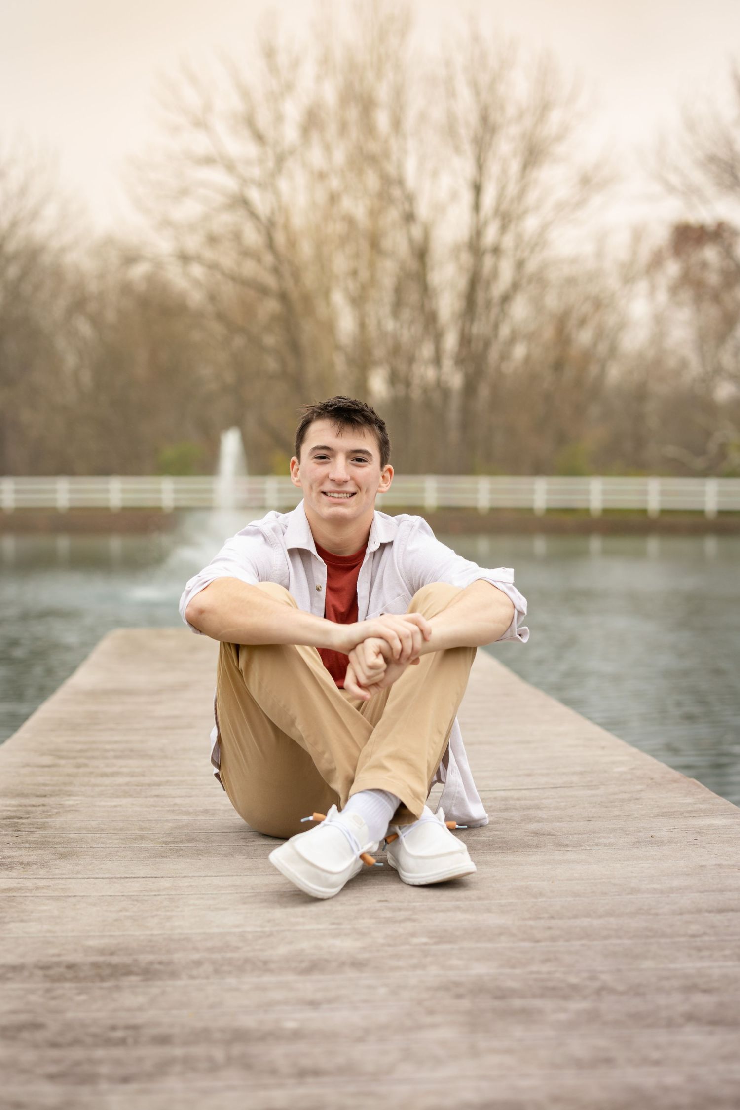 High school senior boy photographed in soft natural light during an individual portrait