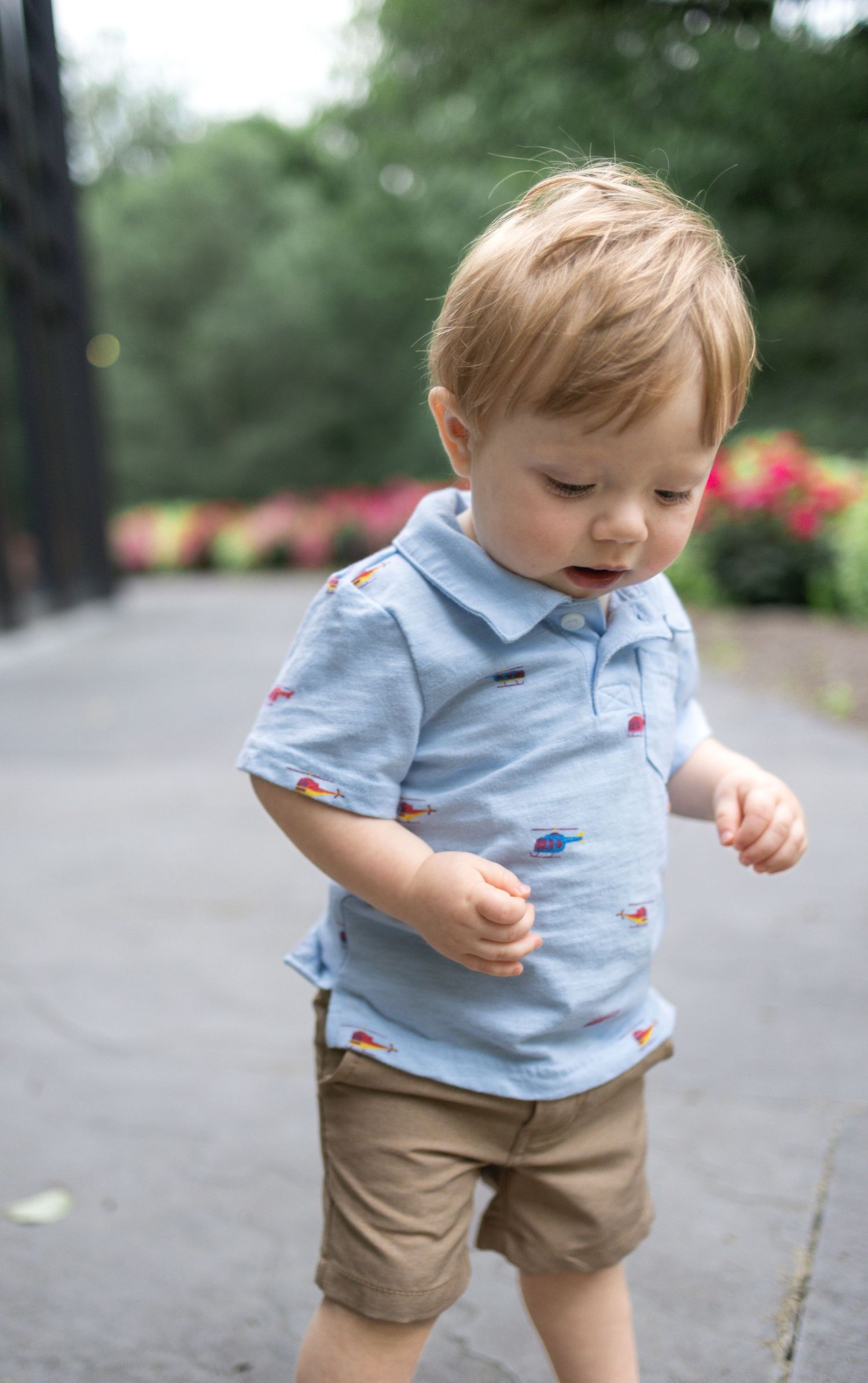 Toddler boy in blue polo looks down at Donegal Presbyterian Church in Mount Joy, PA during family session with Lancaster, PA photographer.