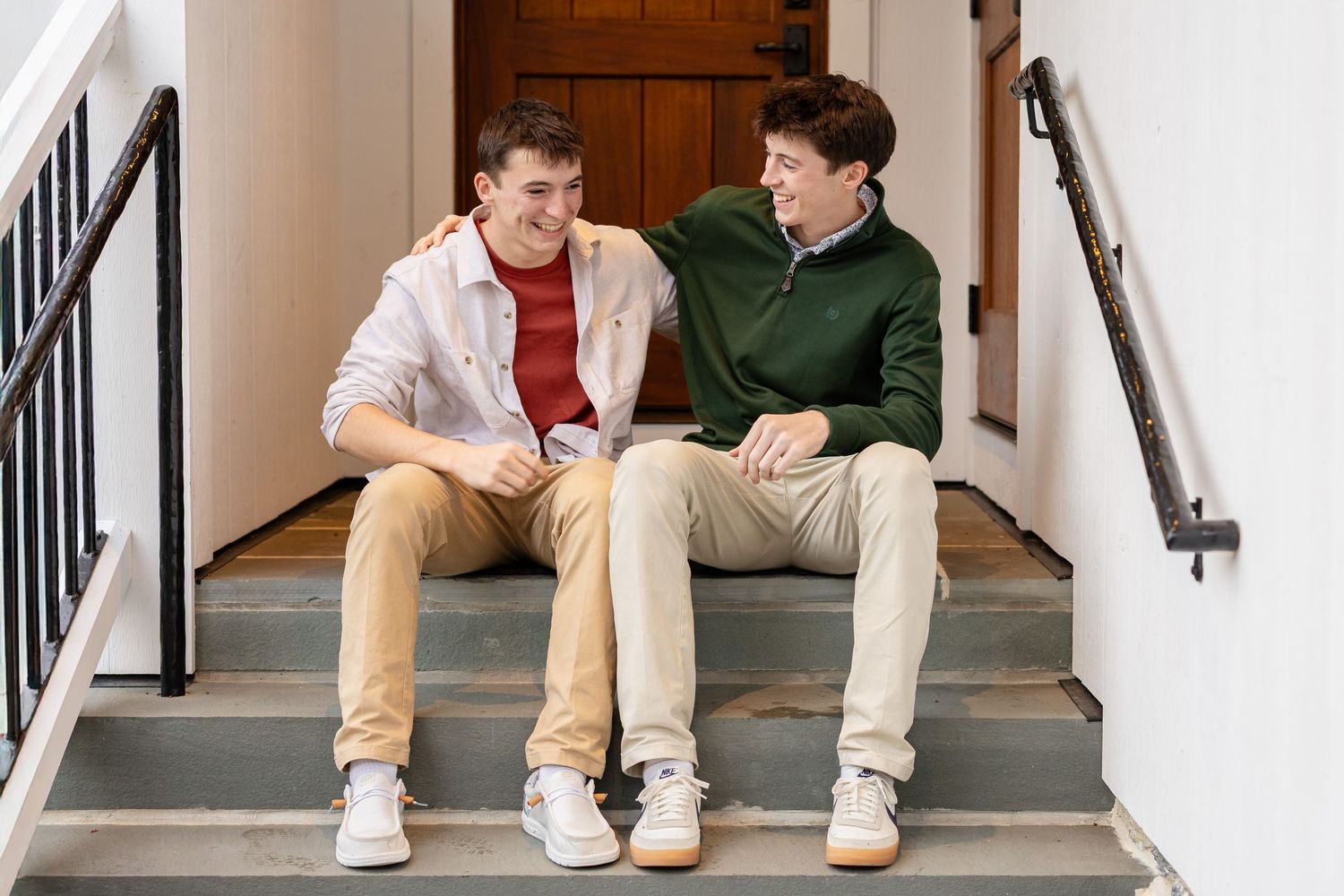 Two high school senior brothers photographed together in soft natural light